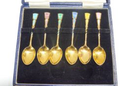 A set of six silver gilt and polychrome enamel coffee spoons, Birmingham 1963, by Turner & Siimpson,