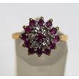 A diamond and ruby cluster ring, stamped '18ct',