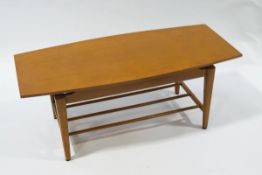 A Canadian Imperial coffee table, with tapering legs, linked by turned stretchers,