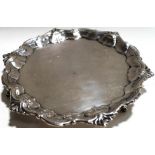 A mid-18th century silver salver of shaped circular form, the border with cast foliate motifs,