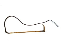 An early 20th century ladies hunting crop, the bamboo shaft with antler handle and silver collar,