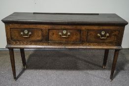 An 18th Century oak dresser base with three frieze drawers on later turned legs,