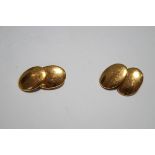 A pair of 15 carart gold cufflinks, London 1925, of plain oval panels with oval connector links,