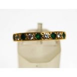 An 18 carat gold half hoop eternity ring, set with five emeralds and four diamonds,