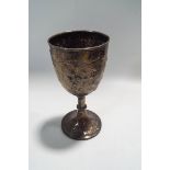 A Victorian silver goblet engraved and embossed with flowers in panels and rocaille,