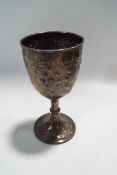 A Victorian silver goblet engraved and embossed with flowers in panels and rocaille,