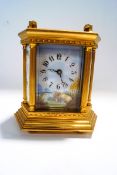 A 20th Century French brass carriage clock, inset with six enamel panels,