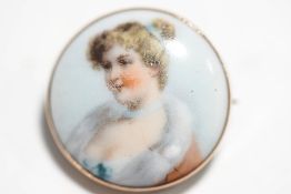 A porcelain brooch, probably German, circa 1900, the transfer printed image of a young girl, 2.