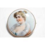 A porcelain brooch, probably German, circa 1900, the transfer printed image of a young girl, 2.