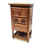 A late 19th century French carved oak cupboard,