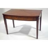 A 19th Century mahogany bow front side table on square tapering legs,