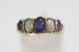 A 9 carat gold sapphire and opal ring, with five alternate set graduated stones, finger size R1/2,