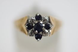 A 9 carat gold sapphire and diamond cluster ring, illusion set with single cuts, finger size M1/2,