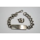 A silver identity bracelet, of filed curb links, 22 cm long, with two removed links, 57.