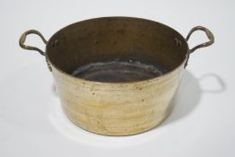 An 19th century brass two handled jam pan, overall 46.