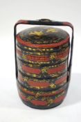 A Chinese lacquered sectional wedding basket, comprising of four containers and cover,