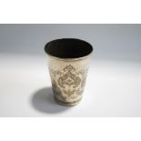 An Iranian silver beaker, stamped marks to the base engraved with foliage flanked by exotic birds,