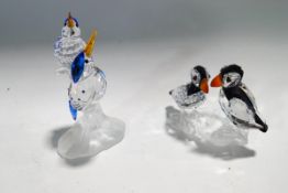 Two Swarovski Crystal bird ornaments: a pair of Kingfishers and a pair of Puffins,