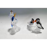 Two Swarovski Crystal bird ornaments: a pair of Kingfishers and a pair of Puffins,