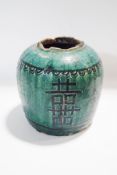 An antique Oriental pottery ginger jar, with green glaze and hand painted decoration,