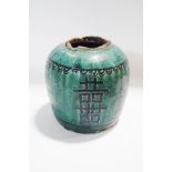 An antique Oriental pottery ginger jar, with green glaze and hand painted decoration,