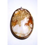 A shell cameo pendant brooch, carved with a female in profile, 5 cm long,