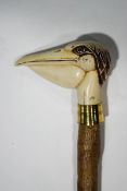 A walking stick with resin pelican's head handle