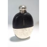 A large glass hip flask with half leather and half silver plate covering and hinged top,