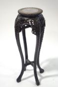 A 19th century Chinese carved jardiniere stand, inset with marble top,