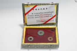 A Chinese presentation case of three square hole coins,