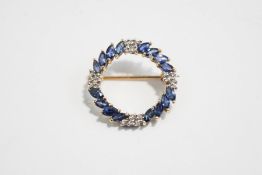 A diamond and sapphire circlet brooch, stamped '9K',
