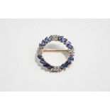 A diamond and sapphire circlet brooch, stamped '9K',