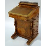 A Victorian inlaid walnut davenport, with leather writing surface and lidded galleried compartment,