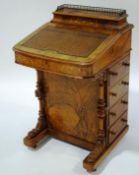 A Victorian inlaid walnut davenport, with leather writing surface and lidded galleried compartment,