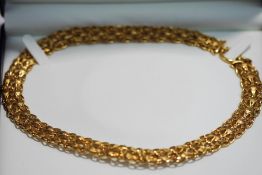 A 9 carat gold collar, of wide matt and polished panels and links, to a large bolt ring clasp, 1.