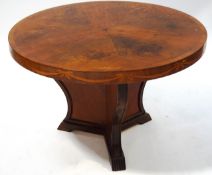 An Art deco walnut coffee table, cross-banded and inlaid with ribbon swags on shaped base,