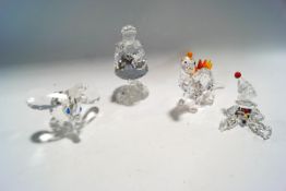 Four Swarovski Crystal ornaments: Dinosaur, Red Riding Hood, Dumbo, Clown,