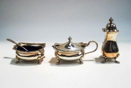 A matched three piece silver condiment set, Birmingham 1953 and 1955, with blue glass liners,