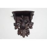 A small Black Forest wall bracket, carved as a deer's head among foliage,