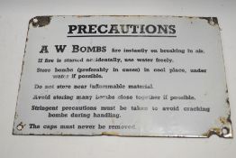 A WWII enamel 'Precautions' sign, for A W Bombs, 20.5cm x 30.