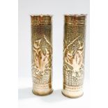 A pair of trench art shell case vases, with hammered decoration and birds in relief,