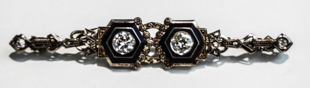 A two stone diamond brooch, the brilliant cut diamonds totalling approximately 1 carat,