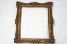 A gilded gesso picture frame, with shell and scroll moulding, inner size 74.5cm x 64.