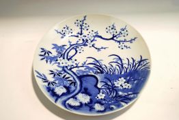 A 20th century Chinese blue and white dish, with prunus decoration,