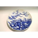 A 20th century Chinese blue and white dish, with prunus decoration,