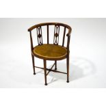 An Edwardian stained beech tub chair, with turned and tapering legs,