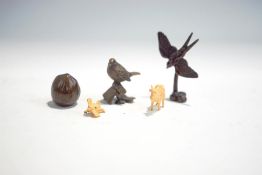 Three miniature bronze models of a hazelnut, swallow, bird on a flower pot,