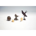 Three miniature bronze models of a hazelnut, swallow, bird on a flower pot,