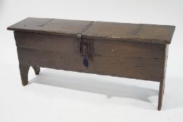 An early 17th century oak four plank coffer, with iron strapwork hinges , lock and key,