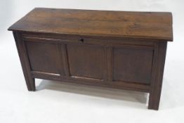 A 17th century oak coffer with triple panelled front, 66cm high, 130cm wide,